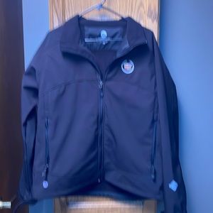 Woman’s Stormtech black jacket, size large, Cadillac insignia, never worn.